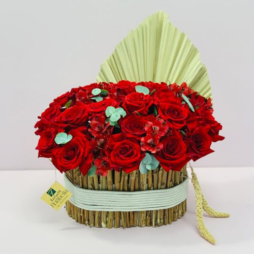 red roses with some dry flowers special arrangement in handmade wooden basket