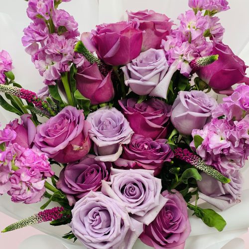 dark purple and light purple colour roses and mixed flowers