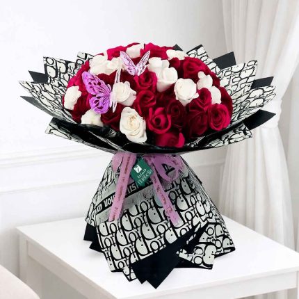 Luxury bouquet of 50 fresh white and red roses beautifully wrapped in premium paper for birthdays, anniversaries, weddings, Valentine's Day and same-day flower delivery across Doha, Qatar.