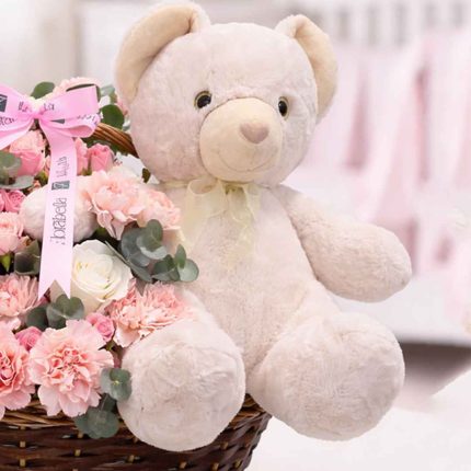 Luxury teddy bear and fresh flower arrangement in a woven basket, perfect gift combo for birthdays, anniversaries, love, congratulations, and special occasions with same-day flower delivery in Qatar by Florabella Flower