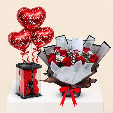 Luxury red roses bouquet combo with an I Love You heart foil balloon and a red foam rose teddy bear. Perfect romantic gift for Valentine's Day, anniversaries, birthdays, proposals, and special occasions with same-day flower delivery in Doha, Qatar.