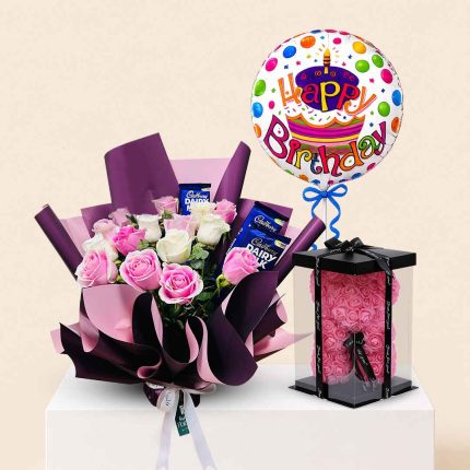 Luxury birthday gift combo featuring pink and white roses bouquet, Dairy Milk chocolates, foam rose teddy bear, and Happy Birthday foil balloon with same-day flower delivery in Doha, Qatar by Florabella Flowers.