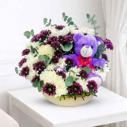Luxury teddy bear and fresh flower arrangement in a woven basket, perfect gift combo for birthdays, anniversaries, love, congratulations, and special occasions with same-day flower delivery in Qatar by Florabella Flowers