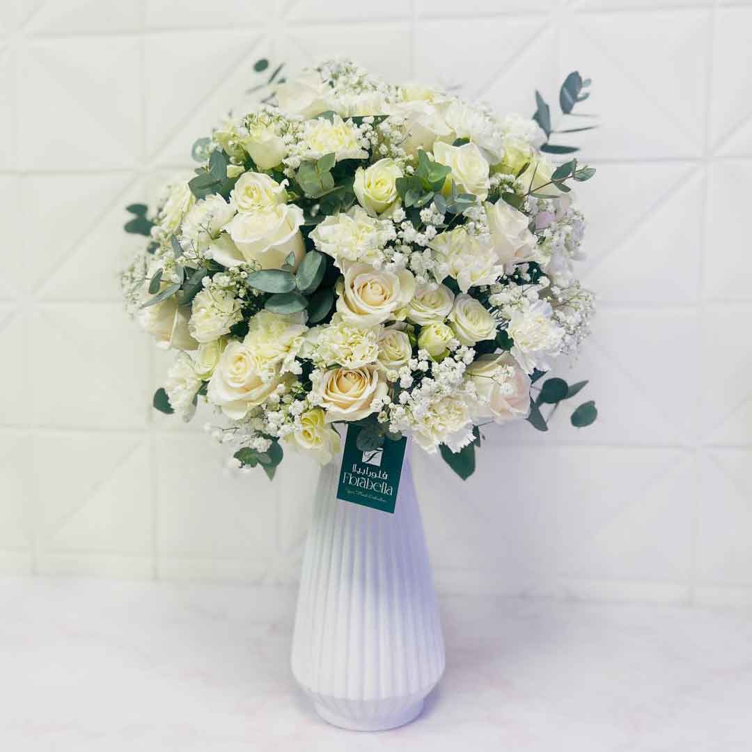 uxury White Roses in Glass Vase Premium fresh white roses beautifully arranged in an elegant glass vase with luxury styling, perfect for birthdays, weddings, anniversaries, sympathy, corporate gifts, and same-day flower delivery across Doha and Qatar.
