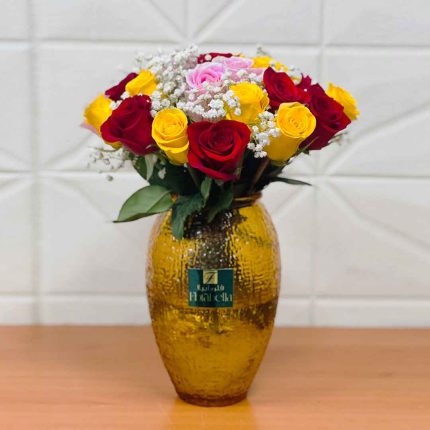 Premium mixed colour roses beautifully arranged in an elegant glass vase with fresh red, pink, white, yellow and peach roses for luxury flower delivery in Doha, Qatar.