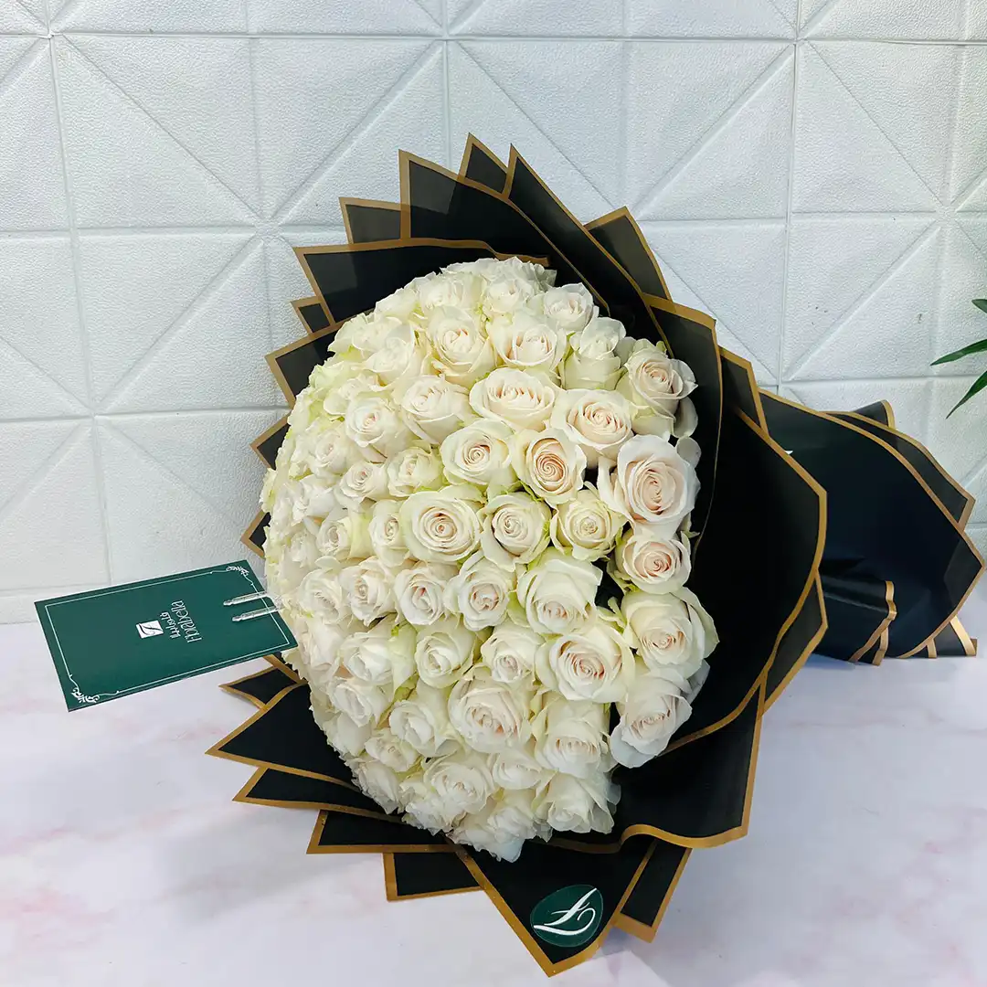 100 White Rose Bouquet – Luxury White Roses in Qatar 100 white roses bouquet in elegant luxury wrapping for flower delivery in Qatar