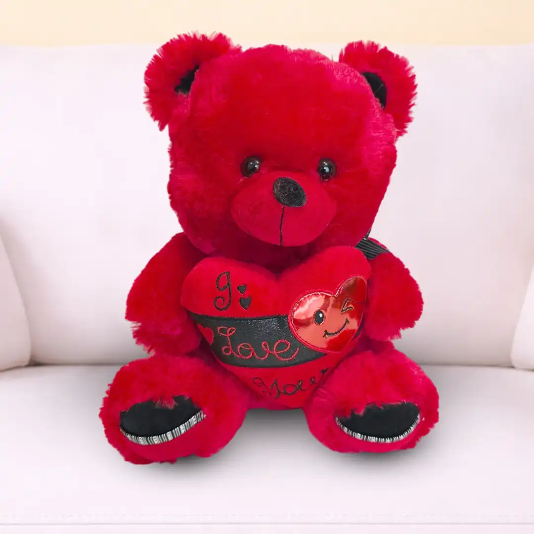 35 cm Red Teddy Bear with “I Love You” Print – Romantic Gift Qatar 35 cm red teddy bear soft toy with I Love You printed message, romantic gift available at Florabella Flowers Qatar